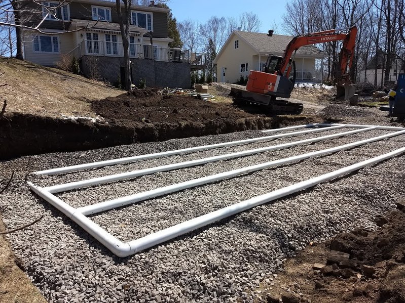 The drain field component of a residential septic system is being put in place. Creative Commons license.